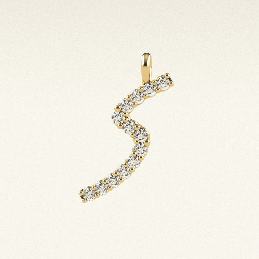 Gold and diamond 'S' pendant on a beige background