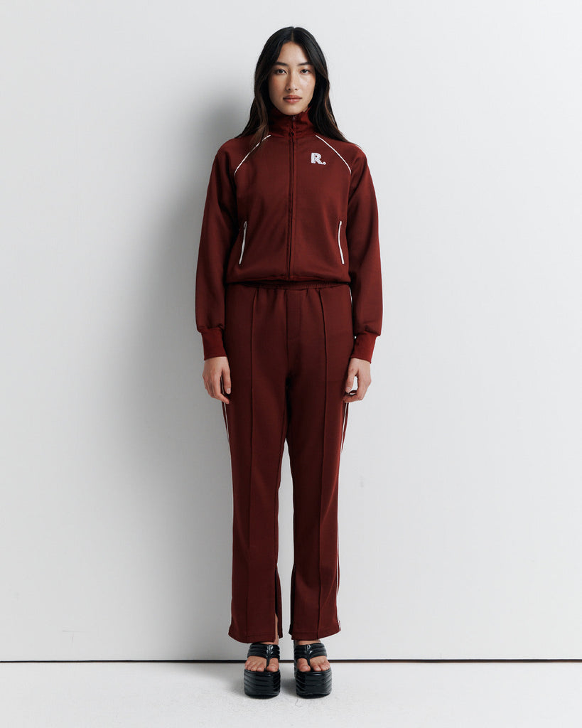 The RAS Sweater is a sports-inspired zip-front jacket featuring a high neck, contrast piping, and a slim fit. Designed with side zip pockets, chunky ribbed cuffs and hem, and finished with our signature Romy Athletic Society 'R' embroidery at the front.