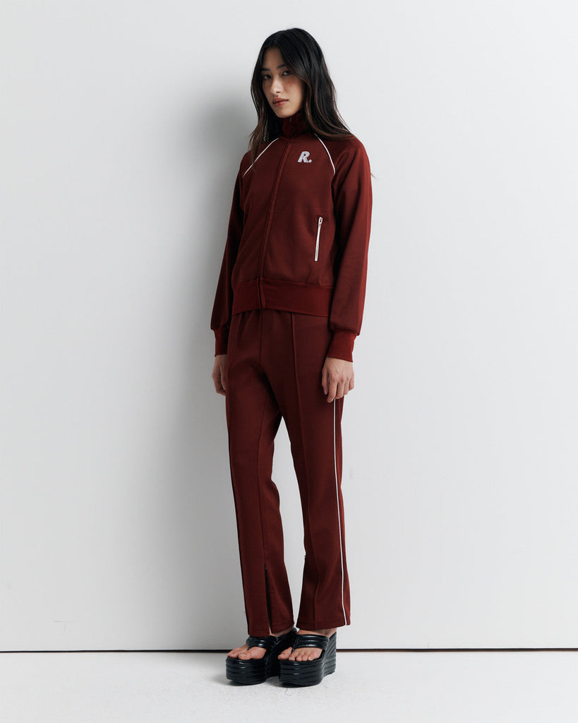 The RAS Sweater is a sports-inspired zip-front jacket featuring a high neck, contrast piping, and a slim fit. Designed with side zip pockets, chunky ribbed cuffs and hem, and finished with our signature Romy Athletic Society 'R' embroidery at the front.