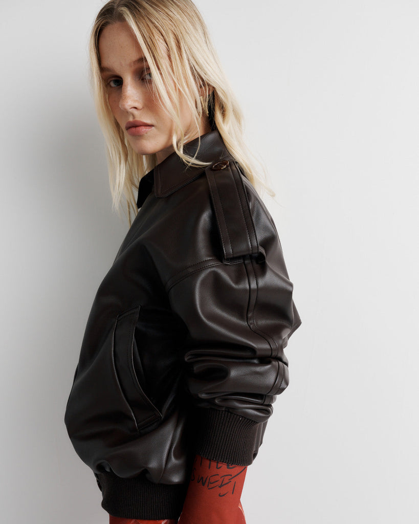 Elevate your wardrobe with the Blair Jacket – a unique bomber-meets-cropped-trench crafted from signature vegan leather. Cinched cuffs and waistband sculpt a flattering silhouette, while the relaxed fit offers effortless drape