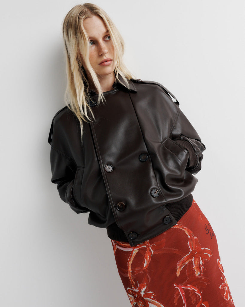 Elevate your wardrobe with the Blair Jacket – a unique bomber-meets-cropped-trench crafted from signature vegan leather. Cinched cuffs and waistband sculpt a flattering silhouette, while the relaxed fit offers effortless drape