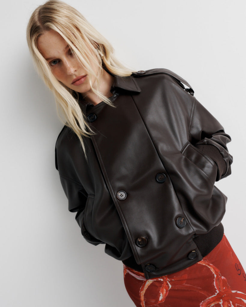 Elevate your wardrobe with the Blair Jacket – a unique bomber-meets-cropped-trench crafted from signature vegan leather. Cinched cuffs and waistband sculpt a flattering silhouette, while the relaxed fit offers effortless drape