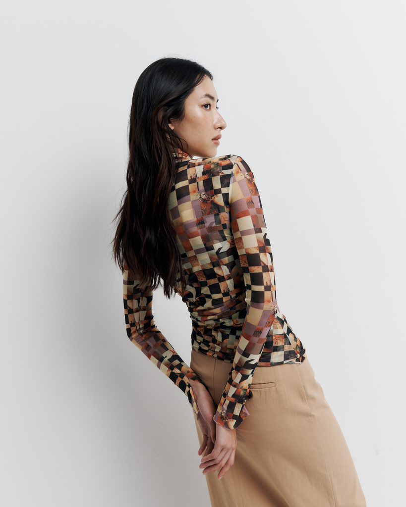 The Blake Top – Double-layer mesh funnel neck with side seam gathering to flatter the form, bell sleeves, and exclusive artwork by Phoebe Wills.