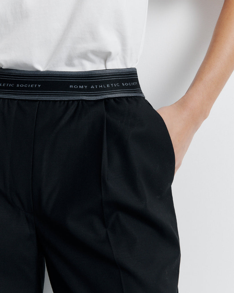 The RAS Pant by Romy Athletic Society combines everyday comfort with elevated style. Crafted from a luxurious wool blend, it features a sporty elastic waistband, side pockets, a faux fly, and a single welt back pocket.