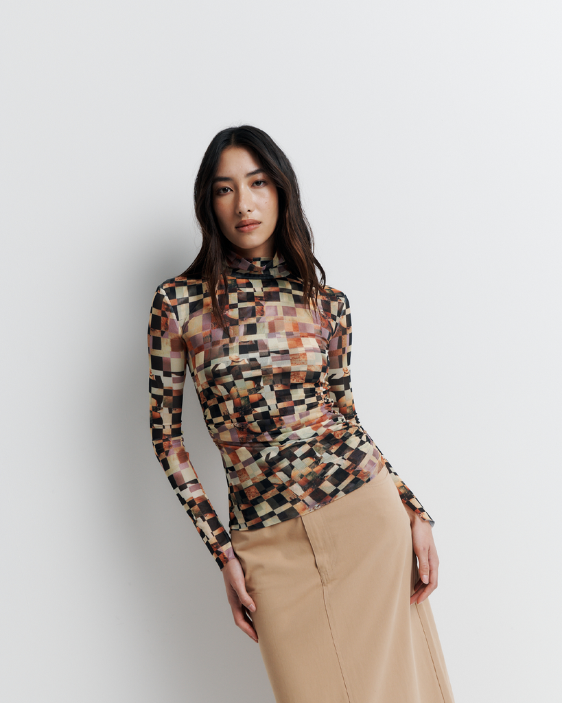 The Blake Top – Double-layer mesh funnel neck with side seam gathering to flatter the form, bell sleeves, and exclusive artwork by Phoebe Wills.