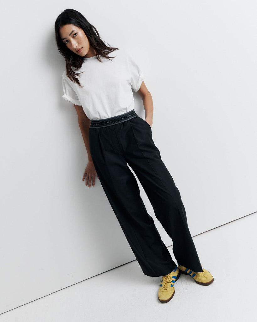 The RAS Pant by Romy Athletic Society combines everyday comfort with elevated style. Crafted from a luxurious wool blend, it features a sporty elastic waistband, side pockets, a faux fly, and a single welt back pocket.