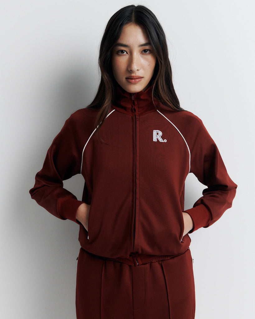 The RAS Sweater is a sports-inspired zip-front jacket featuring a high neck, contrast piping, and a slim fit. Designed with side zip pockets, chunky ribbed cuffs and hem, and finished with our signature Romy Athletic Society 'R' embroidery at the front.