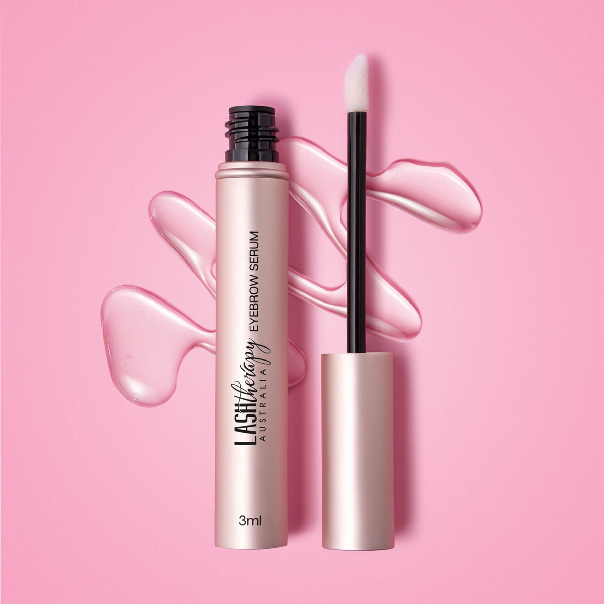 Lash Therapy Australia eyebrow growth serum with peptides with applicator and serum texture on pink background